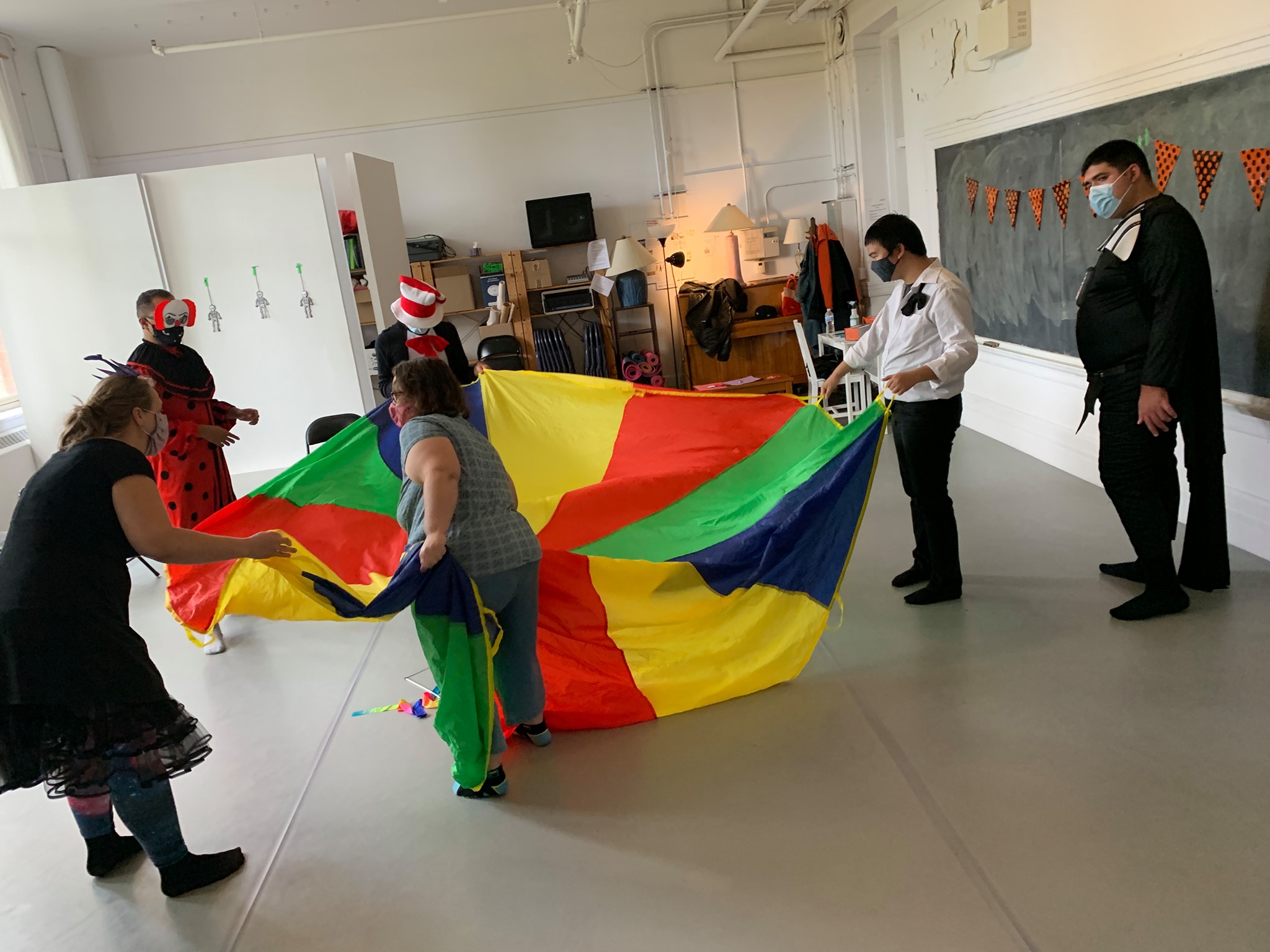 a group of people in a room with a large kite