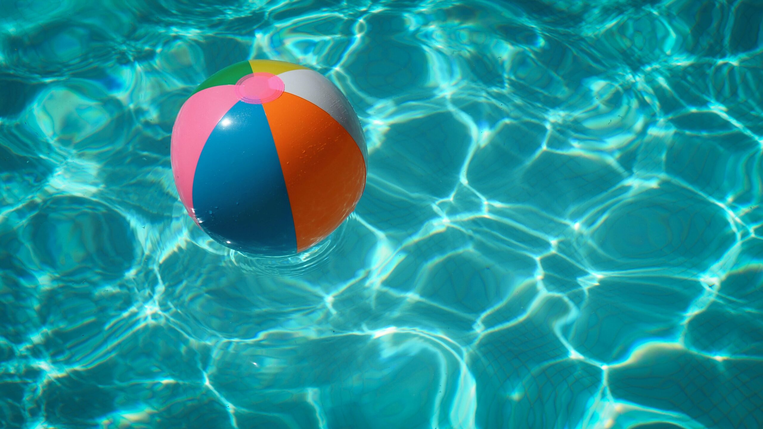 a beach ball floating in a pool of water