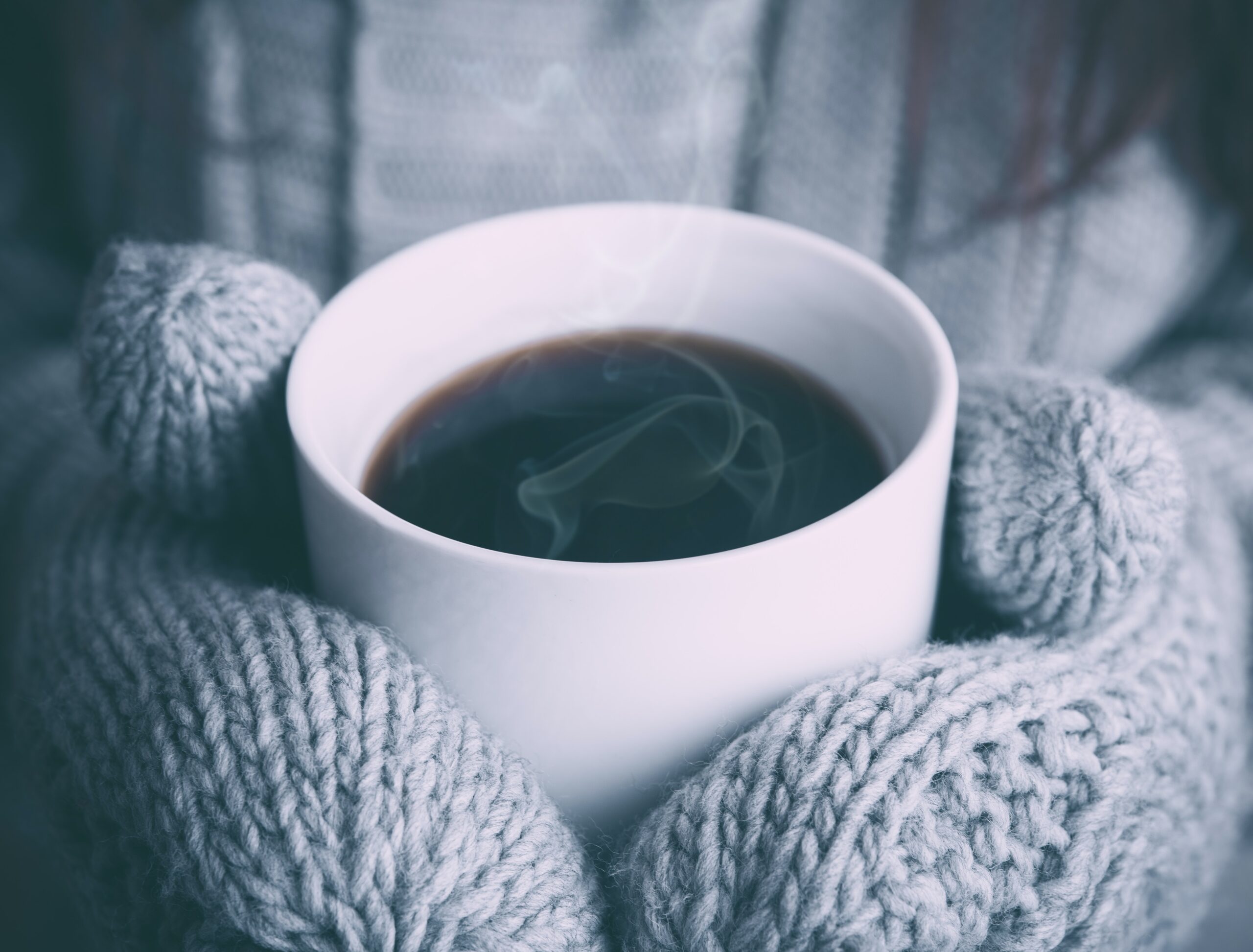 a woman holding a cup of coffee in her hands