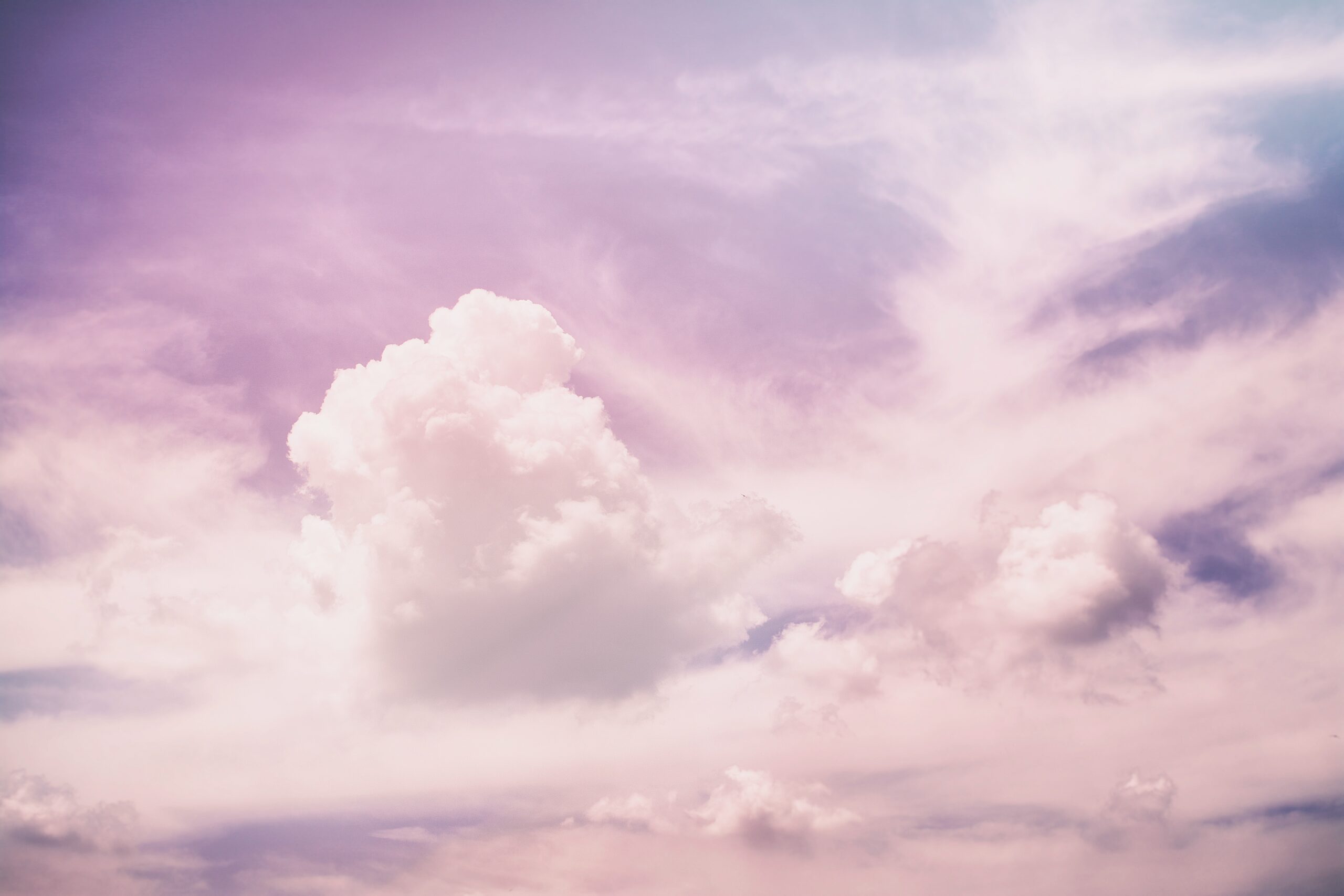 a photo of clouds in the sky, in a purple tone