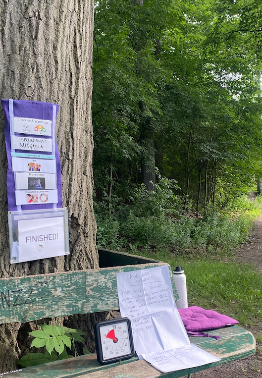 a wooden bench sitting next to a tree