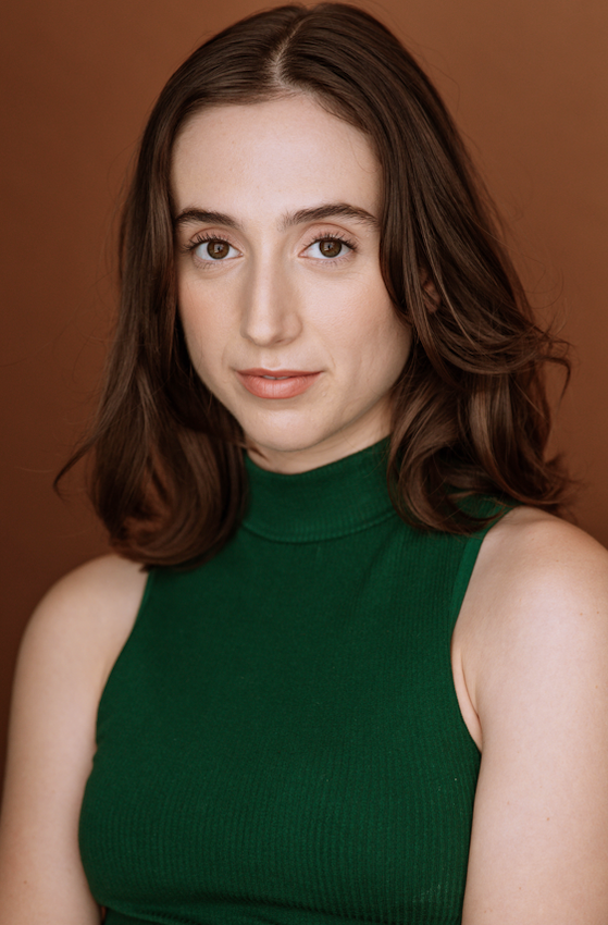 a woman in a green dress posing for a picture