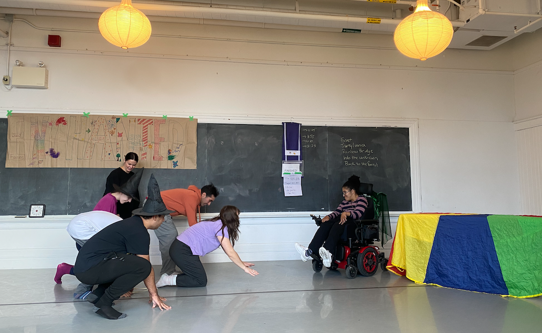 a group of people in a room with a blackboard