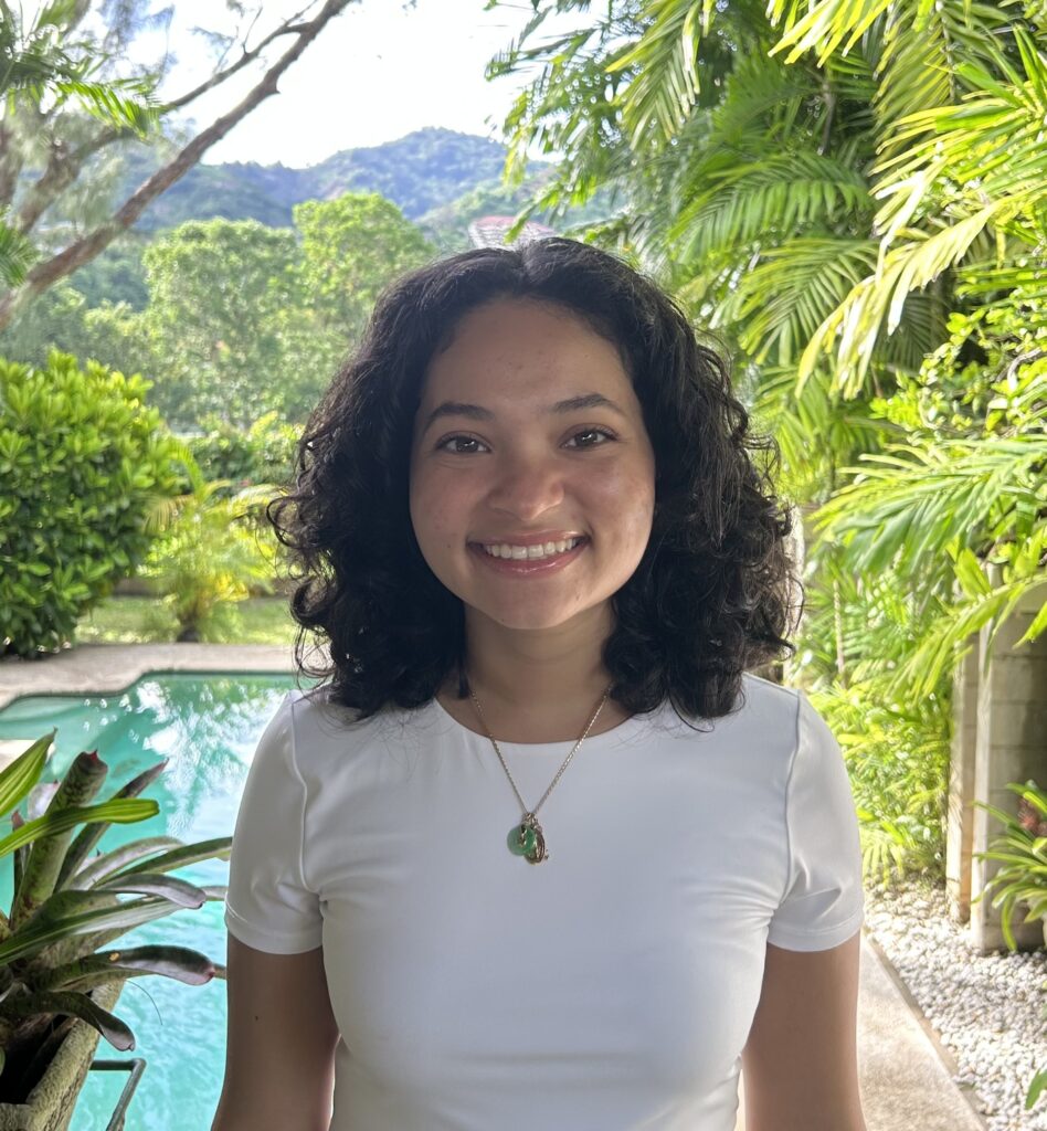 a woman standing in front of a swimming pool