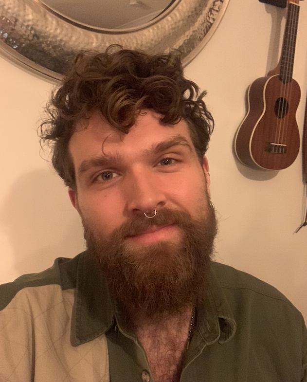 a man with a beard and a nose ring
