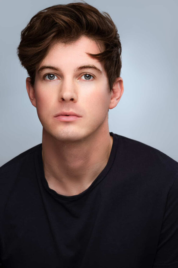 a headshot photo of John McGowan in a black shirt