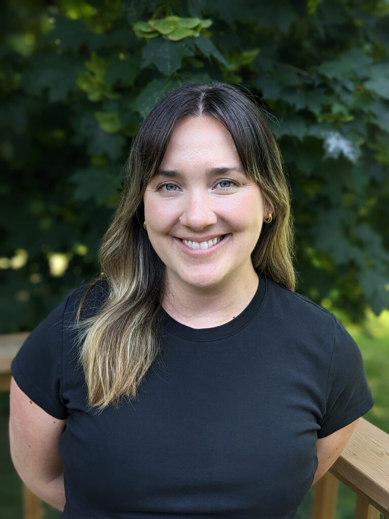 a woman in a black shirt standing on a deck