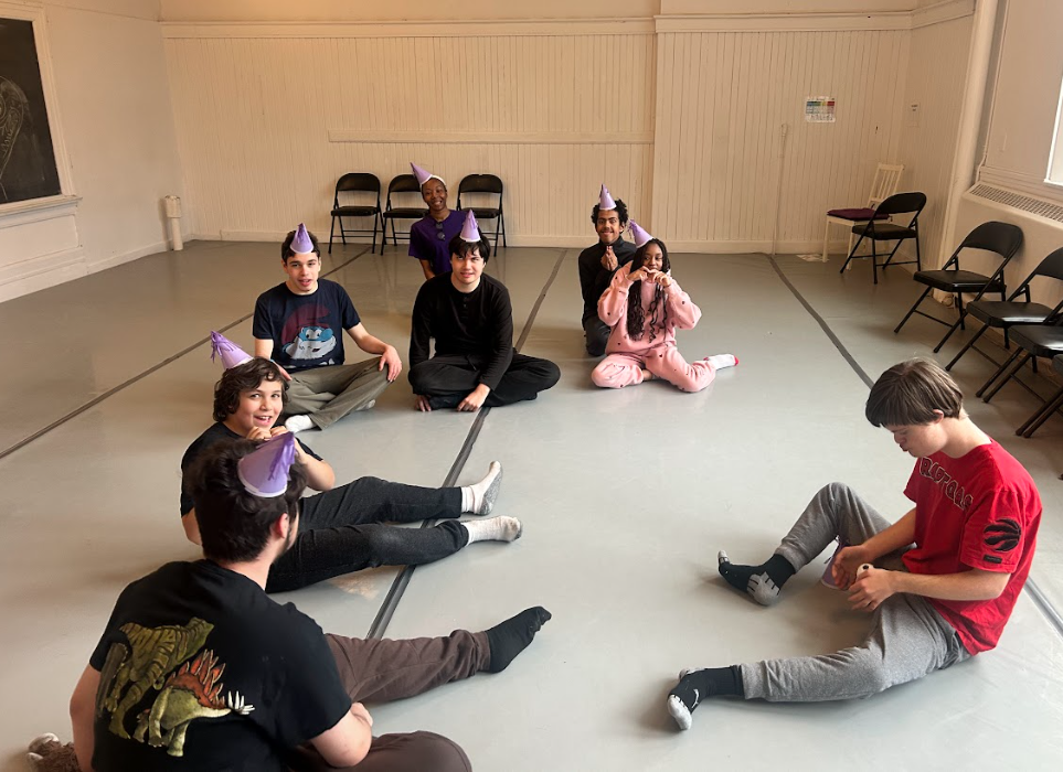 a group of children sitting on the floor in a circle