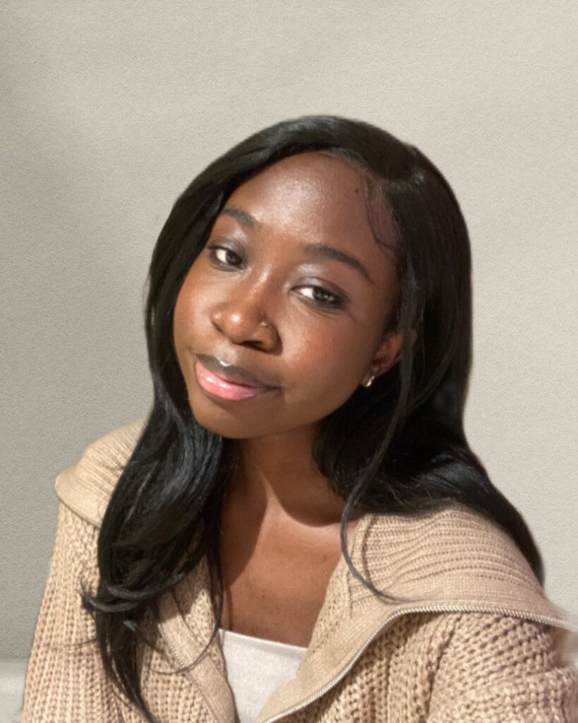 a woman with long black hair sitting down