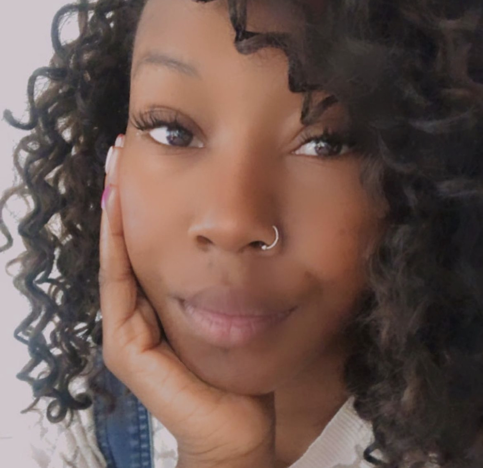 a close up of a person with curly hair